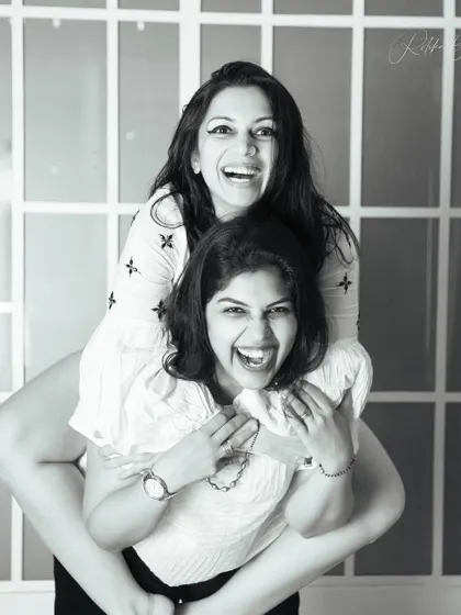Sisters have a world of their own, filled with shared secrets and laughter. This fun, piggyback moment perfectly captures the playful and loving bond between them.