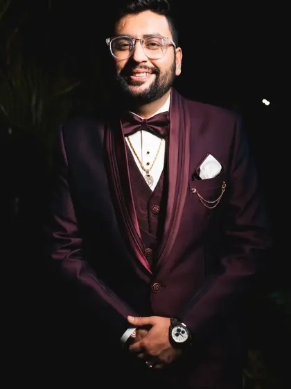 This wine-colored five-piece suit is built for making a statement. The design includes a matching waistcoat and a distinct shawl lapel, all crafted for a sharp, bespoke fit.