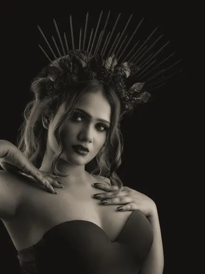 A monochromatic portrait that focuses on the bold shapes and shadows of the gothic makeup. The black and white filter adds a timeless, artistic quality to the image.
