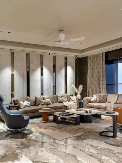 At the heart of this 3,300 sq. ft. luxury residence in Shivaji Park, the living room brings together understated elegance and refined functionality. A statement wall etched in marble with ancient texts seamlessly blends heritage with modern design language.