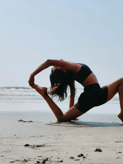 "When you've seen beyond yourself then you may find, peace of mind is waiting there." A deep lunge backbend on the beach, surrendering to the moment.