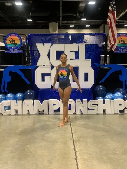 Confidence on the competition floor. One of our Xcel Gold gymnasts ready for her moment at the regional championships.