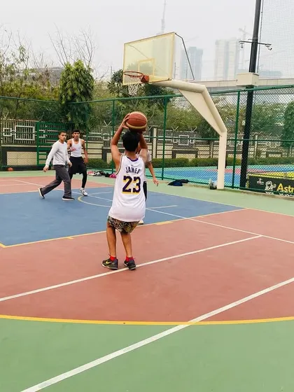 A young player practices his shooting form from mid-range.