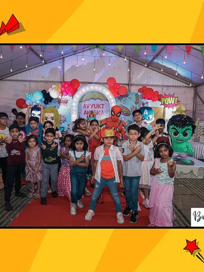 A group of young heroes ready for action! The kids, including a Spider-Man mascot, pose for a photo at this action-packed superhero party.