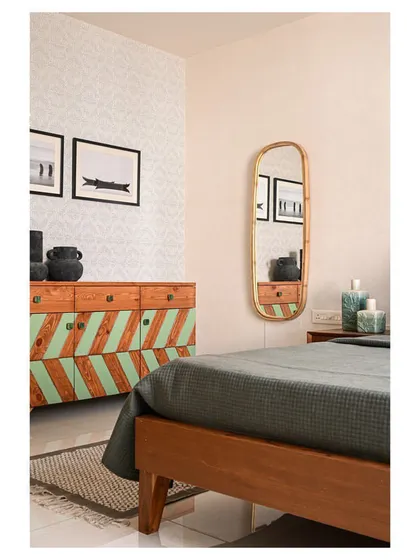 This bedroom features a custom-made console, artwork reminiscent of the owner's sailor background, and a bamboo-framed mirror.