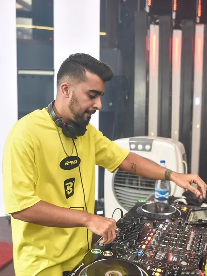 A close-up of me in a bright yellow shirt, focused on the mixer. I'm always ready to sprinkle good vibes on the weekend.
