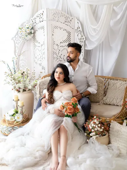 A relaxed and romantic pose for the expecting couple on the studio couch. The mom-to-be is wearing a beautiful white lace gown from my client closet.