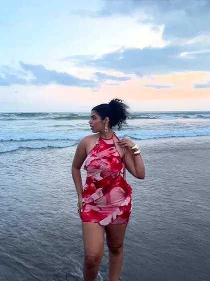 Walking out of the ocean at sunset. This photo captures the dreamy, romantic vibe of a beach evening.
