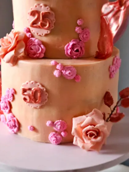 Another detail from the elegant mother-daughter cake, showing the texture of the colored ganache and the placement of the sugar flowers.