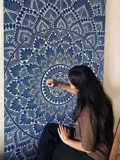 When passion meets focus, magic happens. A close up shot of me working on a detailed blue and white mandala.