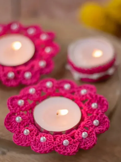 This set features our bright pink, flower-shaped diya coasters with delicate pearl bead details, shown alongside a matching diya jacket. You can mix and match styles to create your perfect festive look.