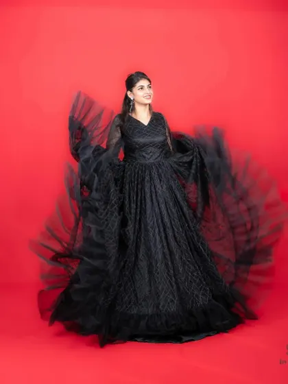 The sleeves of this black gown create a beautiful motion effect when twirled.