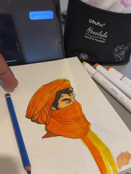 Here you can see the alcohol marker coloring in progress. I'm layering the orange and yellow tones to build up the color of the turban, working directly in my sketchbook.