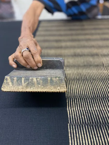 This mid-century modern settee is beautifully upholstered in our hand-printed linen. The 'Sonoma' pattern in Glitter Graphite, designed by Seema Krish, creates a unique texture with its striking yet muted metallic gold on black.