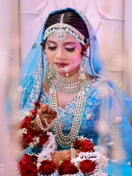 A close-up of the Nikkah bride, her beautiful blue outfit and silver jewelry perfectly complemented by the soft, shimmery eye makeup.