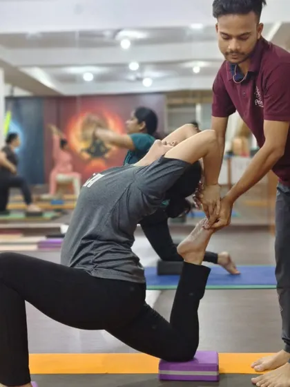 In this assisted Eka Pada Rajakapotasana (One-Legged King Pigeon Pose), I help the student open her chest and shoulders while using a block for stability.