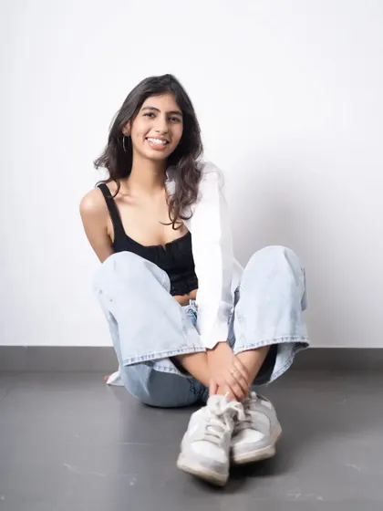 A relaxed, smiling portrait from a model test shoot. This natural and approachable look is essential for a portfolio, showing a different side from more serious, high-fashion shots.
