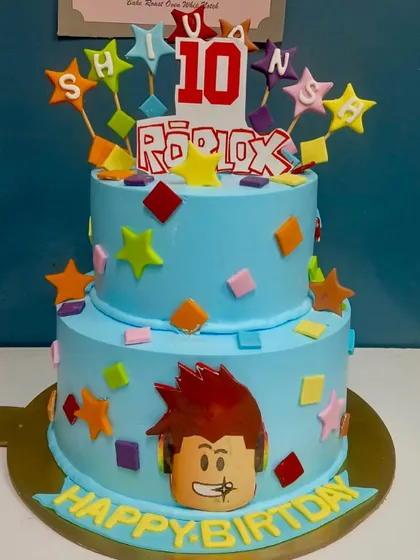 Another take on our popular Roblox theme. This two-tier cake is personalized with the birthday boy's name on colorful stars, ready for his 10th birthday celebration.