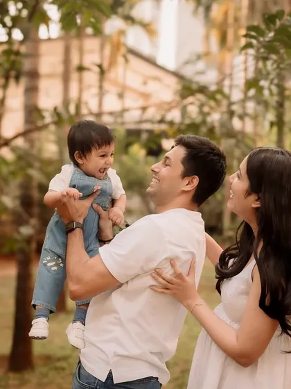 The whole family erupts in laughter in this candid shot, capturing the genuine joy of their time together.
