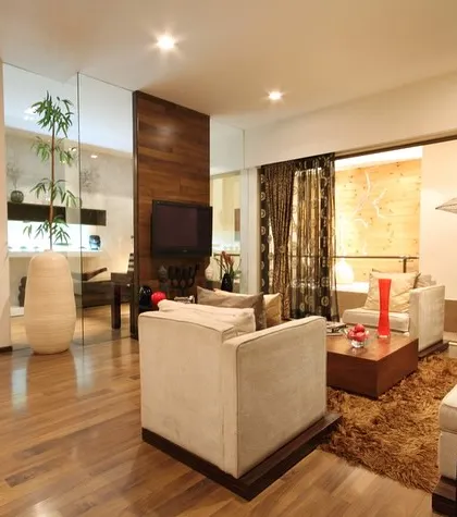 In this older project, our focus was on creating an open-plan living area. By using glass partitions and a consistent wooden flooring, we made the space feel larger, brighter, and more connected.