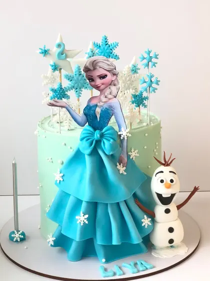 Let it go with this enchanting Frozen cake. It features a beautiful Elsa figure, a tiered dress, and delicate snowflake details, with a friendly Olaf on the side.
