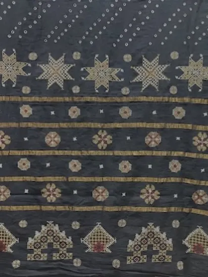 A detail from a Kasuti-embroidered textile, featuring star motifs and temple cart patterns. The beauty of Kasuti lies in its perfect symmetry and the fact that the design is identical on both sides of the fabric.