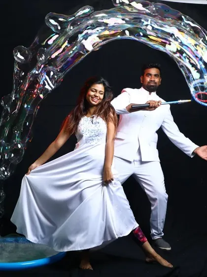 A dynamic studio shot of our bubble performers creating a massive, swirling bubble structure. This showcases the artistry and scale of our bubble acts, perfect for stage shows and grand events.