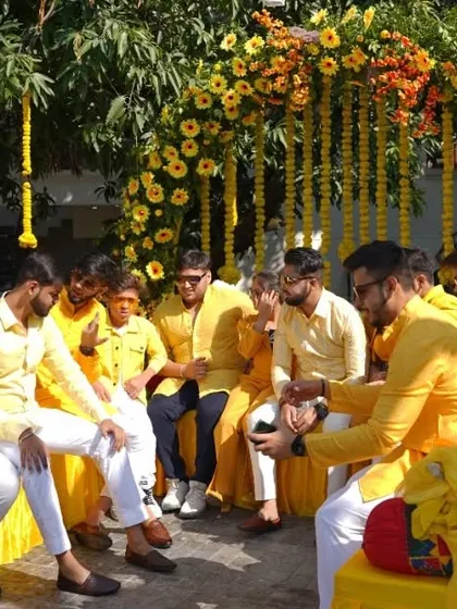 The groom's Haldi ceremony, surrounded by friends and family all dressed in yellow, enjoying the fun-filled rituals.