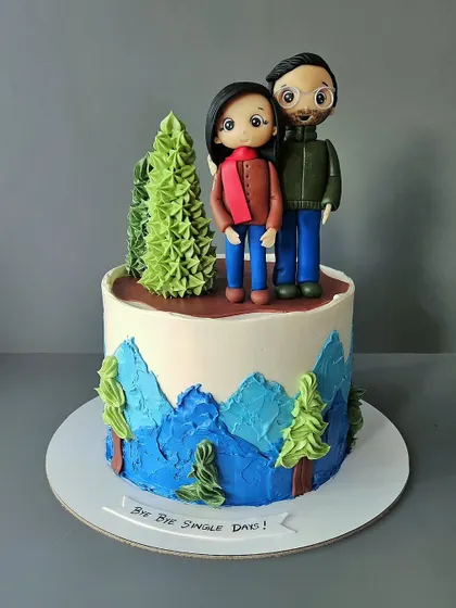 Bye bye single days! A fun cake for a couple who loves hiking. This vanilla and salted caramel cake features custom figurines of the couple, ready for their next adventure together.