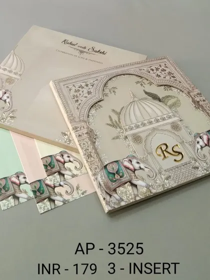 This elegant off-white invitation is adorned with beautifully illustrated elephants and a space for a custom monogram. The set includes three color-coordinated inserts for your various wedding ceremonies.