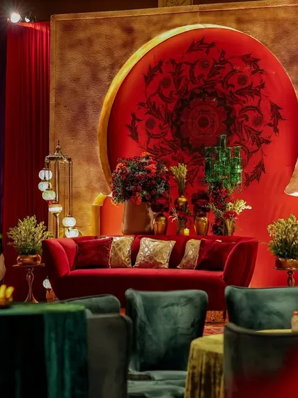 A beautiful composition showing the main stage seating area, framed by a carved arch on one side and the lounge seating in the foreground. The layers of design create depth and visual interest.