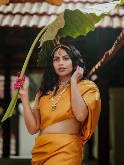 From the 'THAMARA' series, an editorial inspired by traditional Indian paintings. I styled a golden-yellow saree in a unique drape, paired with temple jewelry and dramatic pink-stained fingertips to create a divine, apsara-like figure.