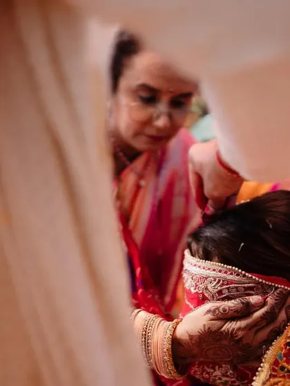 An emotional moment during a wedding ritual, capturing the bride's expression. We focus on the small, meaningful interactions that tell a larger story.