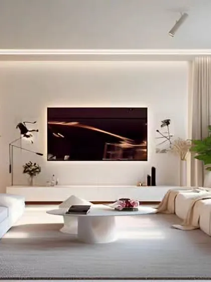 An all-white living room design that creates a feeling of serenity and space. We used soft, comfortable sofas, sheer curtains to maximize natural light, and carefully placed plants to add a touch of nature and life to the minimalist aesthetic.