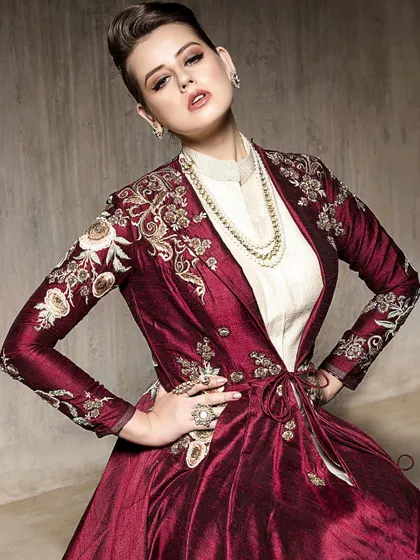 A powerful three-quarter shot with hands on hips, showcasing the intricate embroidery on the jacket sleeves. This pose exudes confidence and is perfect for highlighting detailed craftsmanship.