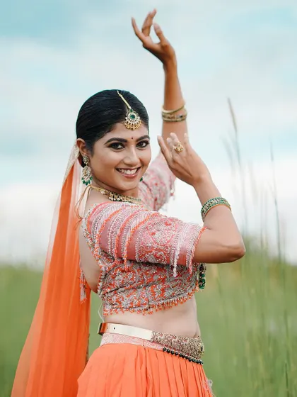 A joyful, candid shot from the same outdoor shoot, capturing the model's smile and the vibrant look.