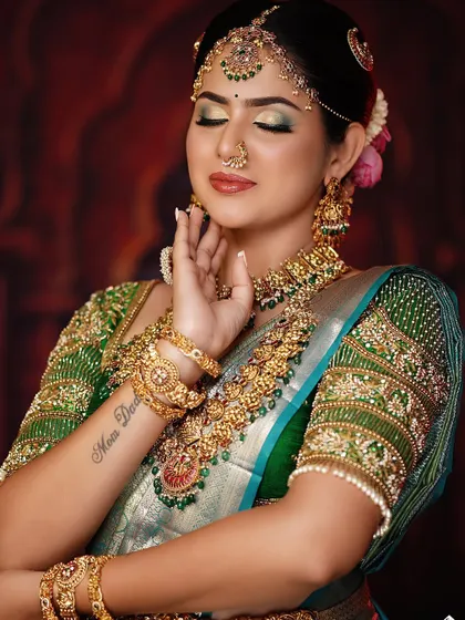 This bridal look features a beautiful green-toned eyeshadow to match the saree, a technique we cover in color theory.