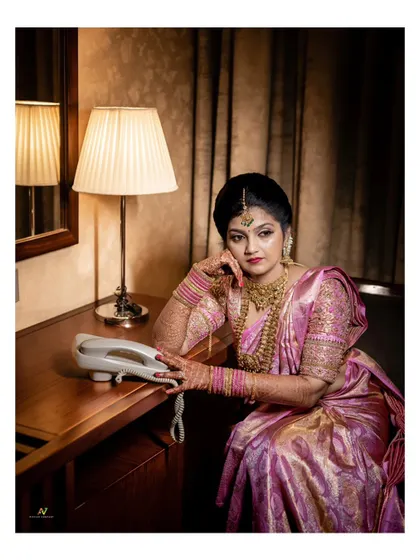 A dramatic and moody bridal portrait, with the bride posing with a vintage telephone.
