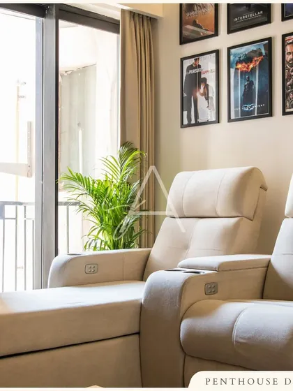 For this penthouse, we created a dedicated home theater space. Comfortable recliners, access to a balcony, and a gallery wall of favorite movie posters make it the perfect spot for cinematic experiences.