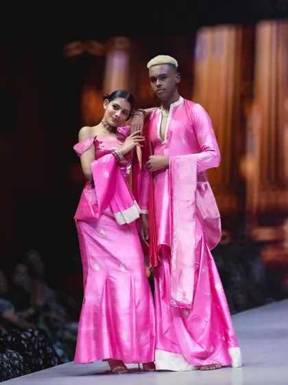 A coordinated look in vibrant pink on the BFW runway. I framed this shot to show the connection between the two models and how the complementary outfits create a cohesive and powerful fashion statement.