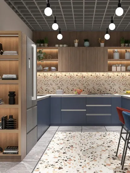 A modern office kitchen featuring bold blue cabinets, a terrazzo backsplash, and open wooden shelving. The design is both functional and stylish.