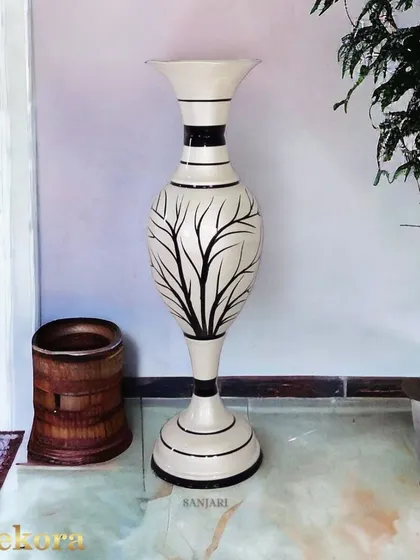 This large floor vase features a striking black tree-branch pattern on a white background. It is a bold, artistic piece that can serve as a focal point in an entryway or a spacious office corner.