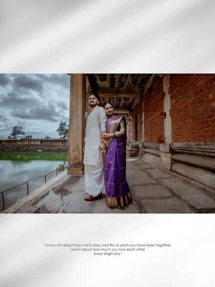 A wide, atmospheric shot of the couple standing in a temple corridor, the dramatic clouds and architecture framing them beautifully.