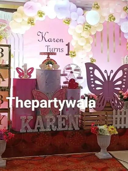 A fairy and butterfly theme with a large stage setup, perfect for a grand first birthday celebration.