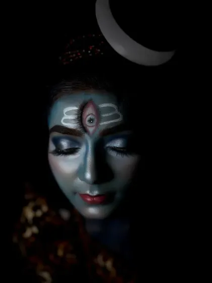 Another contemplative pose, this shot captures the dimensionality of the makeup under soft lighting, showing the careful blending and shading work.