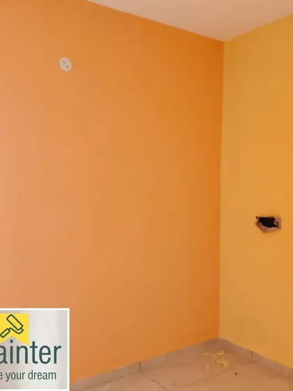 A room painted with two different warm colors, a bright orange and a sunny yellow, creating a very energetic and cheerful space.