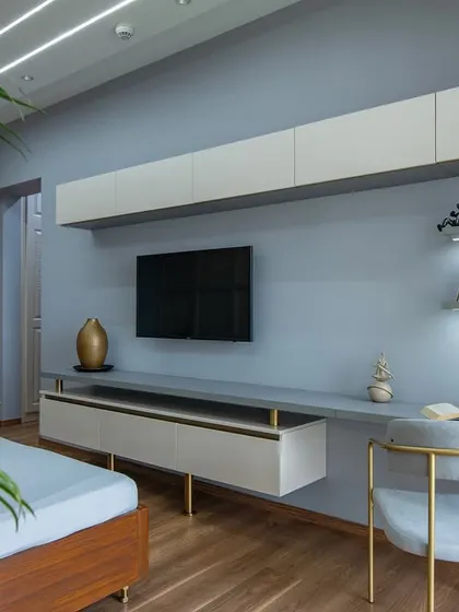 A closer look at the integrated TV and study area. The floating shelves with backlighting are perfect for displaying books and decor, making the space both functional and personal.