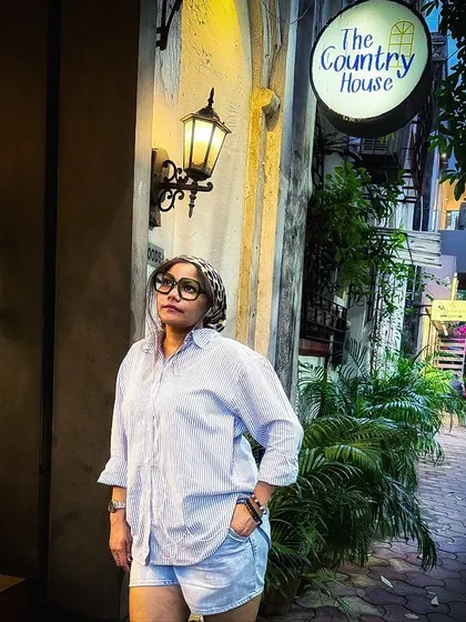 A full-length shot showcasing my outfit in front of the cafe. This blends my fashion content with cafe promotion, showing my followers how to style a look for a cool cafe visit.