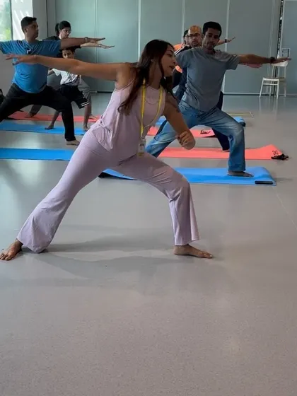 Moving through Warrior II (Virabhadrasana II) with corporate employees. This strong standing pose builds focus, stamina, and confidence.
