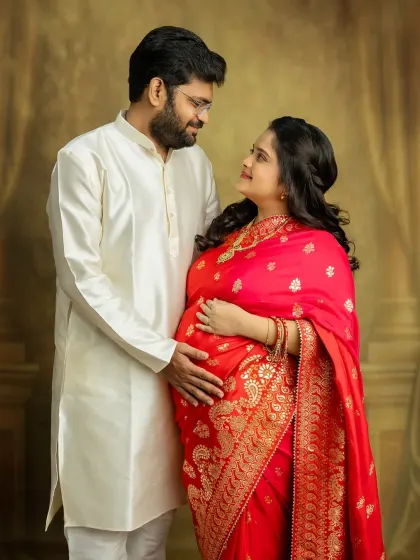 The love in your eyes says it all. This couple's portrait in traditional attire is a beautiful celebration of your journey to parenthood, blending culture with the excitement of what's to come.